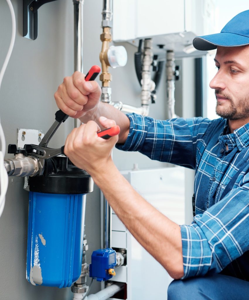 young-plumber-or-technician-installing-or-repairing-system-of-water-filtration.jpg